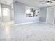 Open living space with a view into the modern kitchen, and marble tile floors at 1836 Mcdaniel St, North Las Vegas, NV 89030