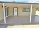 Covered patio featuring white support pillars, a white door, and a large window at 1836 Mcdaniel St, North Las Vegas, NV 89030