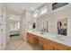 Bathroom showcasing double sinks, a large mirror, and access to a bedroom at 2103 Poppywood Ave, Henderson, NV 89012