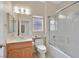Bathroom featuring a vanity, a toilet, and a shower-tub combo with glass doors at 2103 Poppywood Ave, Henderson, NV 89012
