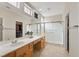 Bathroom featuring a double sink vanity, a walk-in closet and glass shower at 2103 Poppywood Ave, Henderson, NV 89012