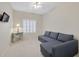 Neutral bedroom with a gray sectional, a side table, and natural light at 2103 Poppywood Ave, Henderson, NV 89012