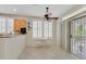 Cozy breakfast nook with white shutters, a ceiling fan, and sliding door access to the patio at 2103 Poppywood Ave, Henderson, NV 89012