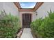 Inviting front entrance with a decorative wrought iron gate and lush greenery at 2103 Poppywood Ave, Henderson, NV 89012