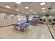 Brightly lit game room with ping pong tables, exercise balls, and a wall mirror at 2103 Poppywood Ave, Henderson, NV 89012