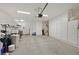 Spacious garage with overhead lighting and built-in wall cabinets for storage at 2103 Poppywood Ave, Henderson, NV 89012