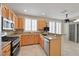Well-lit kitchen with granite countertops, stainless steel appliances, and a breakfast bar at 2103 Poppywood Ave, Henderson, NV 89012