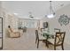 Open-concept living space with tile flooring, a dining area and a comfortable recliner at 2103 Poppywood Ave, Henderson, NV 89012