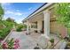 Covered patio with plants, pillars, fan, and outdoor seating area at 2103 Poppywood Ave, Henderson, NV 89012