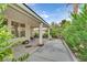 Covered patio with plants, pillars, fan, and outdoor seating area at 2103 Poppywood Ave, Henderson, NV 89012