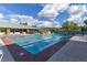 Large community swimming pool with lounge chairs, umbrellas, and clear blue water at 2103 Poppywood Ave, Henderson, NV 89012