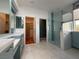 Well-lit bathroom featuring a double sink, walk-in shower, and closet access at 2138 Fort Halifax St, Henderson, NV 89052