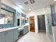 Bathroom featuring dual sinks, walk-in shower, skylight, and a walk-in closet at 2138 Fort Halifax St, Henderson, NV 89052
