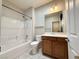 Bathroom features a tub and shower combination, vanity with wood cabinets, and tile flooring at 2138 Fort Halifax St, Henderson, NV 89052