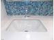 Close-up of a sink with chrome faucet and hexagonal tile backsplash at 2138 Fort Halifax St, Henderson, NV 89052