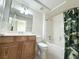Bathroom featuring a vanity with storage, a toilet, and a shower-tub combo with curtain at 2138 Fort Halifax St, Henderson, NV 89052