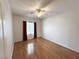 Light-filled bedroom with hardwood floors, ceiling fan, and window with decorative drapes at 2138 Fort Halifax St, Henderson, NV 89052