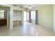 Bright bedroom with tile floors, built in desk area, and an ensuite bathroom and backyard access at 2138 Fort Halifax St, Henderson, NV 89052