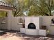 Outdoor fireplace nestled in a cozy courtyard with decorative accent windows at 2138 Fort Halifax St, Henderson, NV 89052