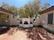 Spacious courtyard offers an outdoor fireplace with tiled flooring and mature trees at 2138 Fort Halifax St, Henderson, NV 89052