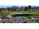 Scenic view of the golf course, featuring a lush green with trees and a pond in the background at 2138 Fort Halifax St, Henderson, NV 89052