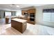 This well-lit kitchen features granite countertops, an island, stainless steel appliances, and a tiled floor at 2138 Fort Halifax St, Henderson, NV 89052