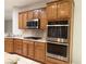 Kitchen features granite counters, stainless steel appliances, and wooden cabinets at 2138 Fort Halifax St, Henderson, NV 89052