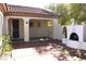 A covered patio has access to the house and an outdoor fireplace in the courtyard at 2138 Fort Halifax St, Henderson, NV 89052