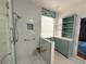 Renovated bathroom featuring a modern glass enclosed shower with blue mosaic tile and seating at 2138 Fort Halifax St, Henderson, NV 89052