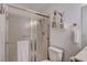 Bright bathroom featuring a shower with glass doors and decorative wall shelves at 227 N Lamb Blvd # B, Las Vegas, NV 89110