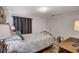Well-lit bedroom with warm touches, including a wrought-iron bed frame and side tables at 227 N Lamb Blvd # B, Las Vegas, NV 89110