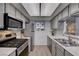 Contemporary kitchen featuring stainless steel appliances, tiled backsplash, and bright lighting at 227 N Lamb Blvd # B, Las Vegas, NV 89110