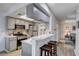Charming kitchen with stainless steel appliances, breakfast bar, and gray cabinets at 227 N Lamb Blvd # B, Las Vegas, NV 89110