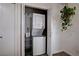 Convenient laundry closet with stacked washer and dryer and hanging plant nearby at 227 N Lamb Blvd # B, Las Vegas, NV 89110