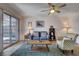 Bright living room with sliding glass doors, ceiling fan, and comfortable seating area at 227 N Lamb Blvd # B, Las Vegas, NV 89110