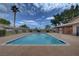 Community swimming pool with palm trees and blue sky views, surrounded by fencing at 227 N Lamb Blvd # B, Las Vegas, NV 89110