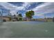 Community tennis court with basketball hoop and mature landscaping on a sunny day at 227 N Lamb Blvd # B, Las Vegas, NV 89110