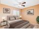 Staged bedroom features neutral walls, tiled floors, large windows and closet, with decoratively staged furniture at 2380 Sierra Sunrise St, Las Vegas, NV 89156