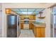 Functional kitchen with granite counters, stainless steel fridge, and wooden cabinets at 2380 Sierra Sunrise St, Las Vegas, NV 89156
