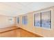 Room featuring a drop ceiling, wood-style floors and three large horizontal windows at 2380 Sierra Sunrise St, Las Vegas, NV 89156