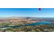 Breathtaking aerial view of a community with stunning mountain and lake views under a clear blue sky and hot air balloon at 244 Paraggi Bay Dr, Henderson, NV 89011