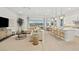 Bright and airy living room with modern furnishings and scenic views from large sliding glass doors at 244 Paraggi Bay Dr, Henderson, NV 89011