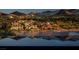Picturesque waterfront homes reflecting beautifully on the calm lake at 244 Paraggi Bay Dr, Henderson, NV 89011