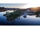 Beautiful waterfront property with a boat, lush landscaping, and architectural design at 244 Paraggi Bay Dr, Henderson, NV 89011