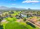 Scenic aerial view of the golf course and surrounding homes with mountain views in the distance, showcasing the community's beauty at 2505 Showcase Dr, Las Vegas, NV 89134