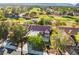 Stunning aerial view of a home on a golf course with mature trees and mountain views at 2505 Showcase Dr, Las Vegas, NV 89134