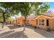 Charming backyard showcasing desert landscaping, trees, and a covered patio for outdoor enjoyment at 2505 Showcase Dr, Las Vegas, NV 89134