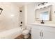 Bathroom with white marble surround, white vanity, framed mirror, and modern black hardware at 2505 Showcase Dr, Las Vegas, NV 89134