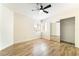 Bedroom with wood-look floors, ceiling fan, and mirrored closet doors for added convenience at 2505 Showcase Dr, Las Vegas, NV 89134