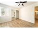 Bedroom with wood-look floors, ceiling fan, and en-suite bathroom for relaxation at 2505 Showcase Dr, Las Vegas, NV 89134